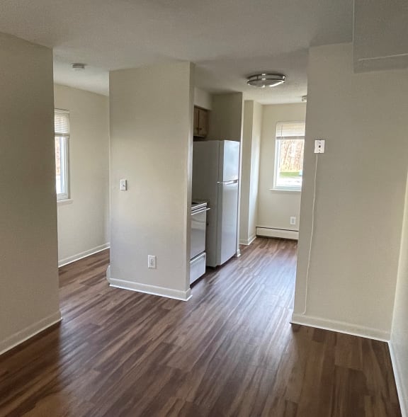 a living room with a refrigerator and a stove