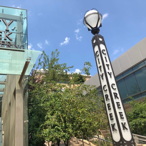 a sign for city creek conservancy in front of a building