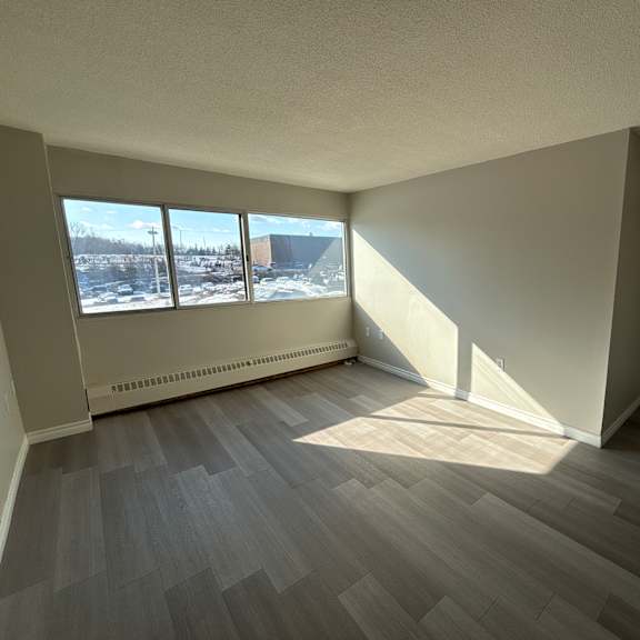 A room with a view of a snowy landscape outside the window.