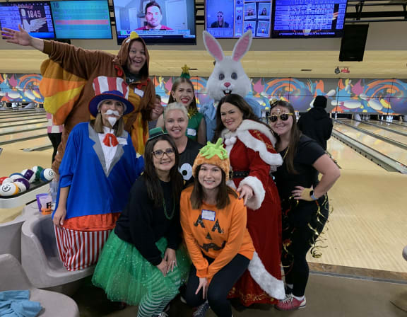 CIP coworkers at a bowling alley dressed up in different holiday costumes