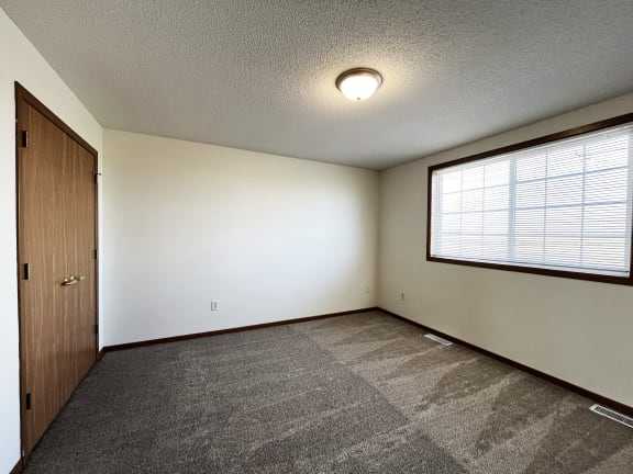 the living room of an empty house with a large window