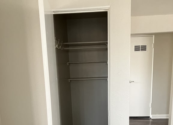 a white shelf with a faucet on a wall in a room