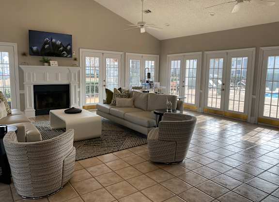 A living room with a fireplace and a television on the wall.