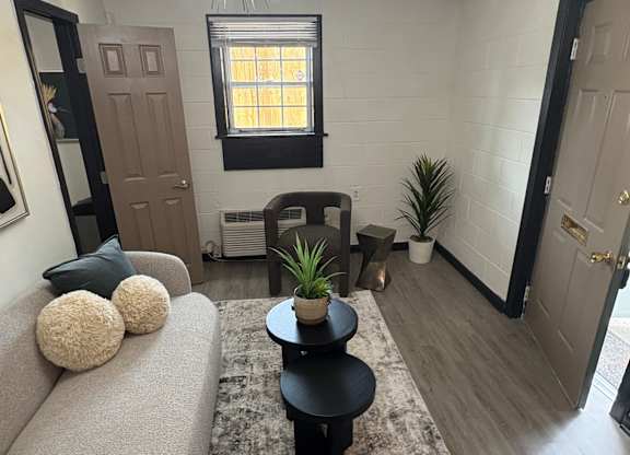 A living room with a grey couch and a wall with a black and white pattern at Waverly Manor Townhomes, Georgia
