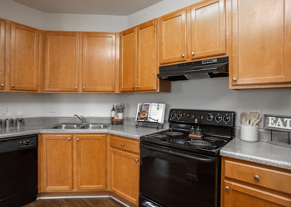 a kitchen with white cabinets and a granite counter top