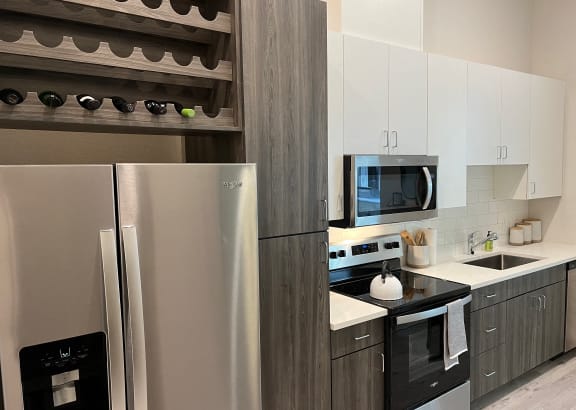 Windsor Park Towers modern kitchen with stainless steel appliances and white cabinets