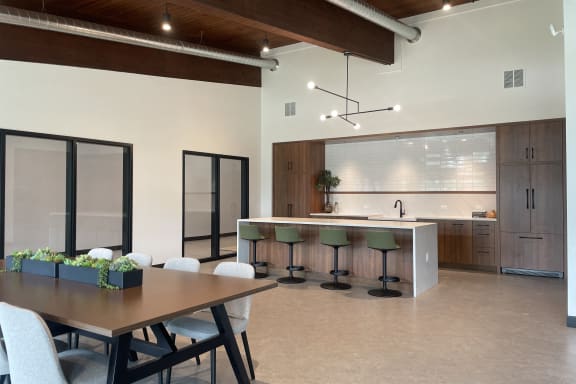 a dining room and kitchen with a table and chairs at The Bosk Apartment Homes, Woodbury
