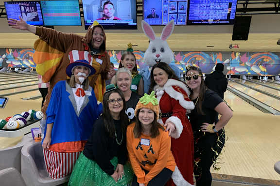 CIP coworkers at a bowling alley dressed up in different holiday costumes