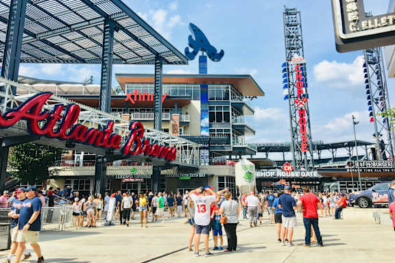 a crowd of people standing in front of the alliant energy center at the baseball