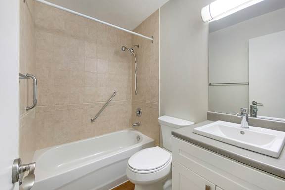 A white toilet sits next to a sink in a bathroom.