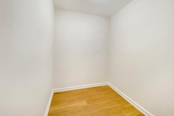 A room with a wooden floor and white walls.