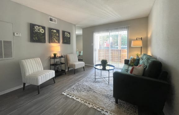 a living room with a couch and two chairs and a table