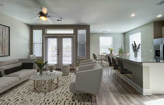 A modern living room with a white sofa, grey armchair, and a glass coffee table.