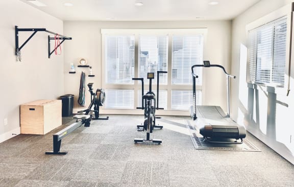 a home gym with weights and a window