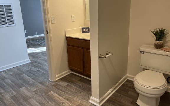 a white bathroom with a toilet and a sink