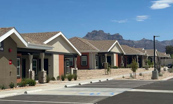 A row of houses with a mountain in the background.