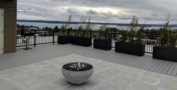 a view of the lake from a balcony with a fire pit