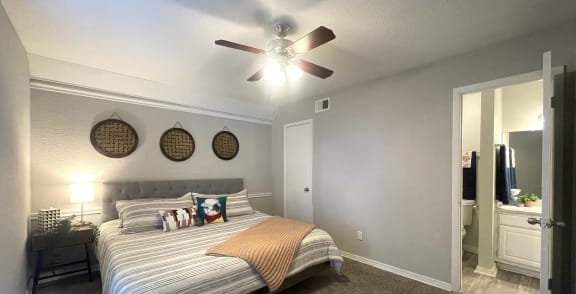a bedroom with a large bed and a ceiling fan