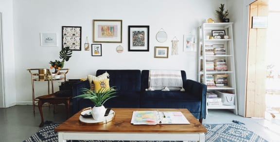a living room with a blue couch and a coffee table
