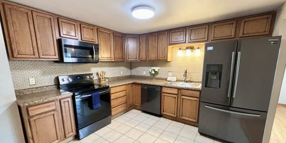 a kitchen with stainless steel appliances and wooden cabinets
