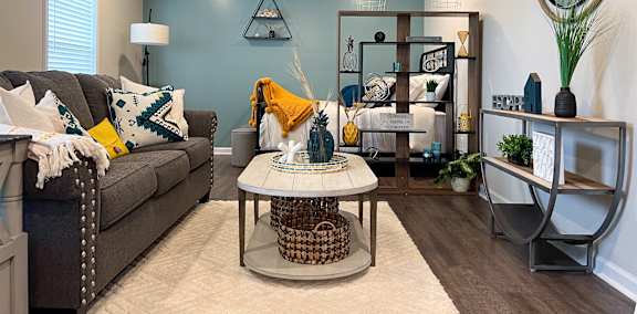 Living and sleeping area in studio apartment with accent wall