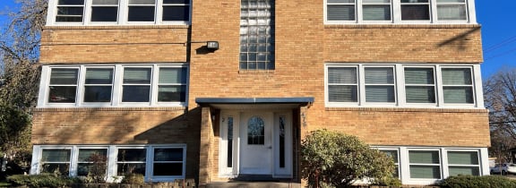 a brick apartment building with a blue sky in the background