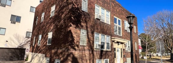 a brick building with a street lamp in front of it
