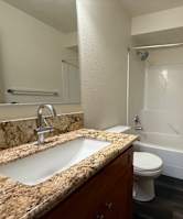 A room with a carpeted floor and a white door.