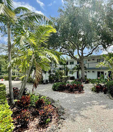 a large white building with a tree in front of it at Lakeside @ Biscayne Gardens,North Miami, FL,33181