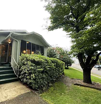 the front of a house with green steps