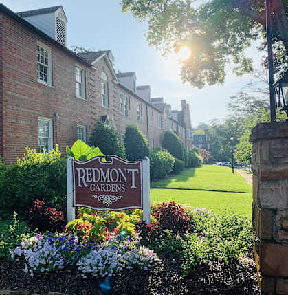 a sign that reads redmont gardens in front of a garden