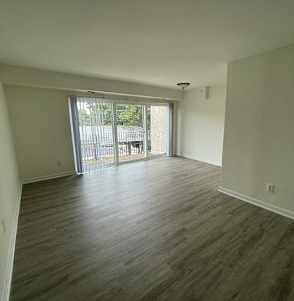 an empty living room with a sliding glass door