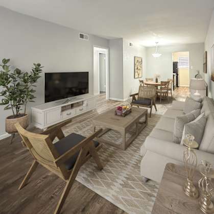 a living room and dining room with a couch and a tv