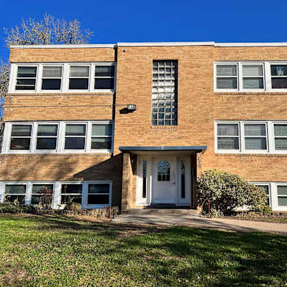 a brick apartment building with a blue sky in the background