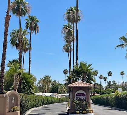 A street with palm trees and a sign that says "Welcome to Sunnyvale".