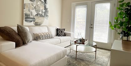 a living room with a white couch and a table at Emery Village, Concord, NC