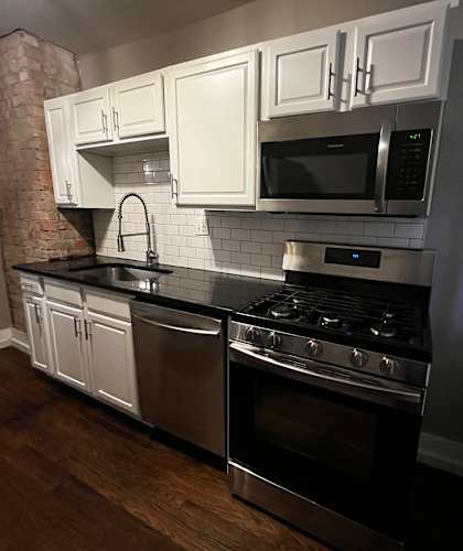 Kitchen with gas stove, microwave, sink