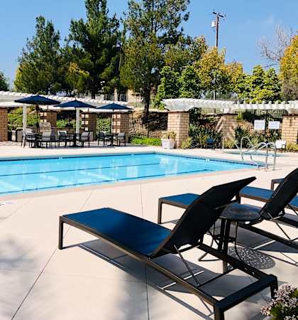 a swimming pool with lounge chairs and umbrellas at Vista Pointe