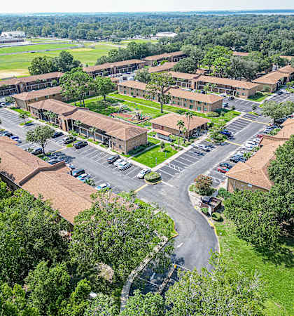 an aerial view of a city with buildings and a parking lot
