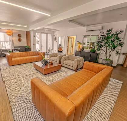 A living room with a large sectional sofa and a coffee table.