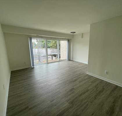 an empty living room with a sliding glass door