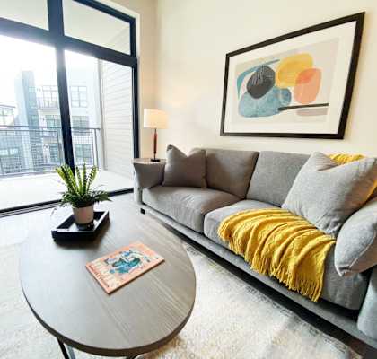 a living room with a couch and a coffee table at Wildhorse Apartments, Chesterfield, Missouri