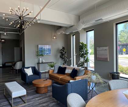 a living room with couches and chairs and a table