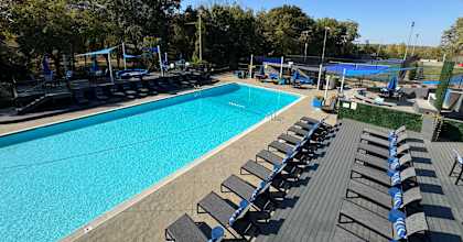an aerial view of a swimming pool with lounge chairs at The Boulevard, Roeland Park, KS, 66205