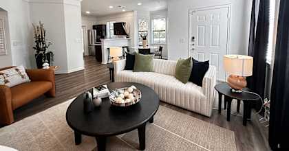 a living room with a couch and a coffee table at Grand Villas Apartments, Katy