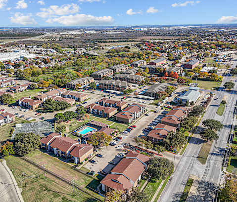 A bird's eye view of a residential area with houses and roads.