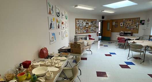 a room filled with tables and chairs with plates and bowls on them