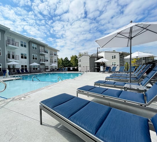 our apartments have a large pool with lounge chairs and umbrellas at Emery Village, North Carolina, 28027