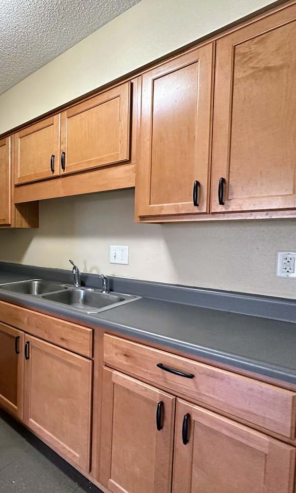 a kitchen with a stove microwave and sink