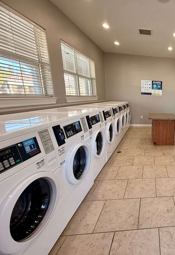 A row of washing machines in a public laundromat.